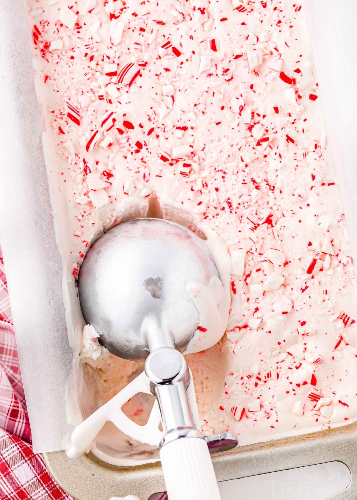 peppermint ice cream being scooped from a loaf pan.