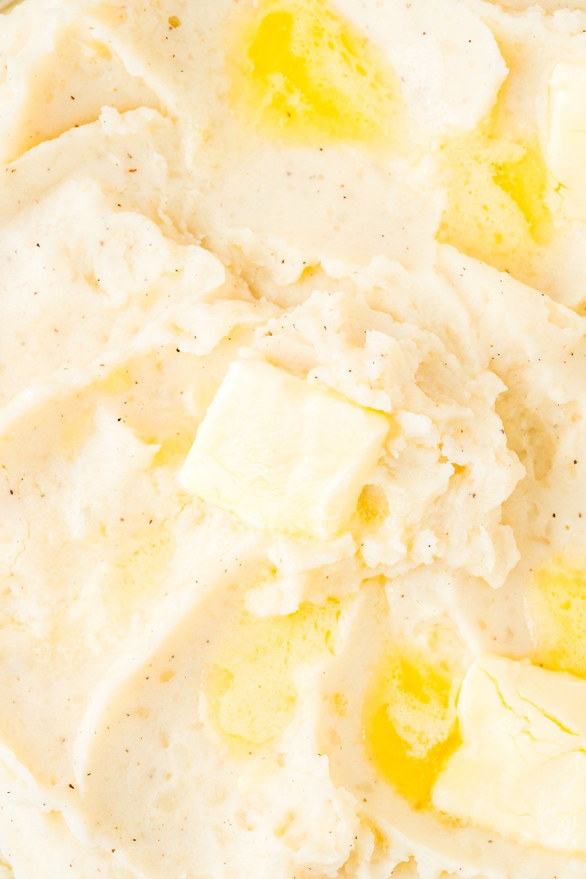 very close up look at instant pot mashed potatoes topped with lots of butter.