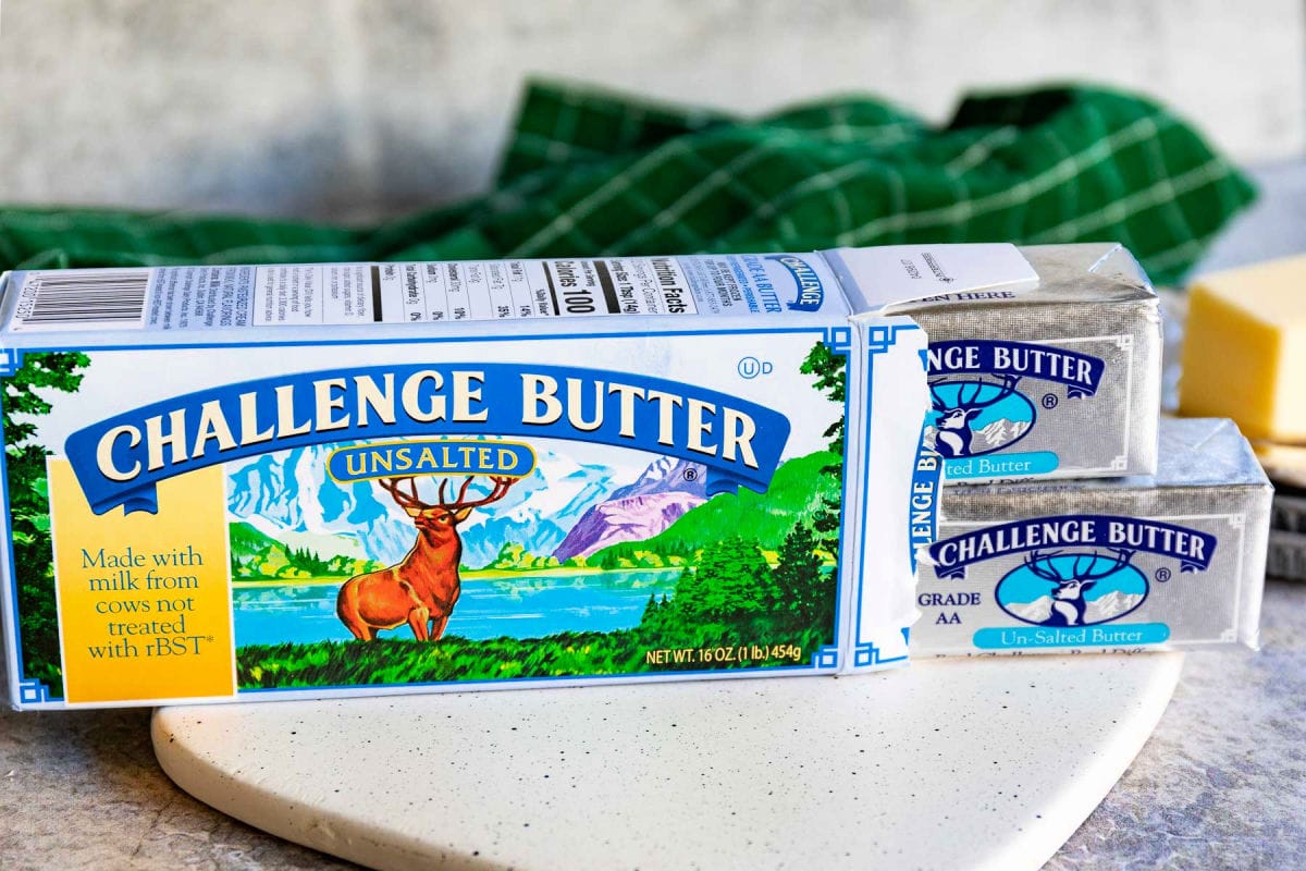 box of challenge butter with two sticks of butter pulled out the end of the box.