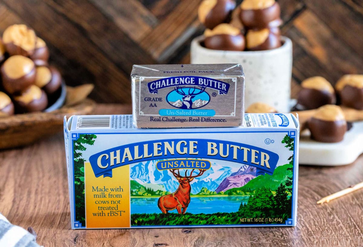a box and stick of challenge butter sitting on front of buckeye candy ready to be enjoyed.