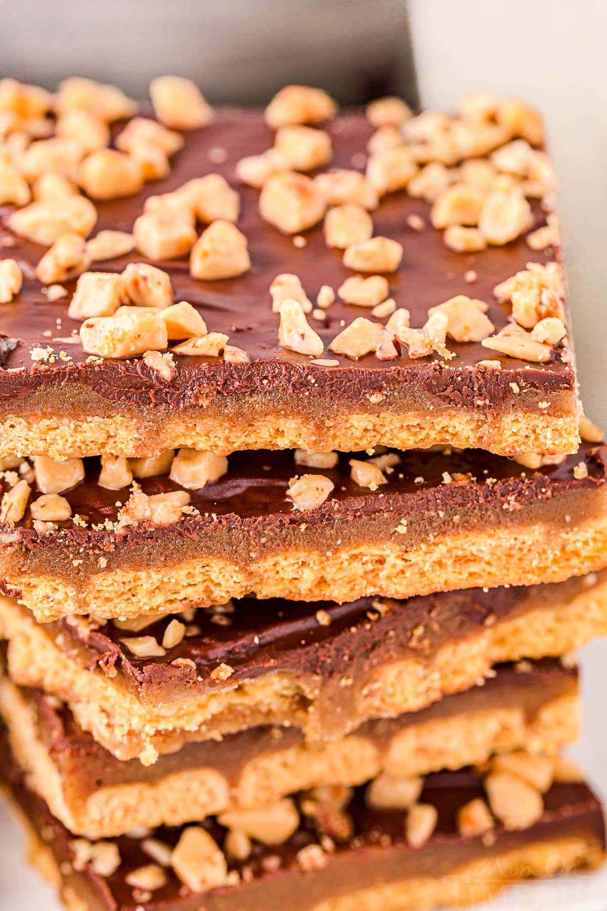 close up look at stack of graham cracker toffee topped with heath toffee bits.