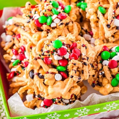 haystacks topped with candy and marshmallows sitting in a red and green Christmas box.