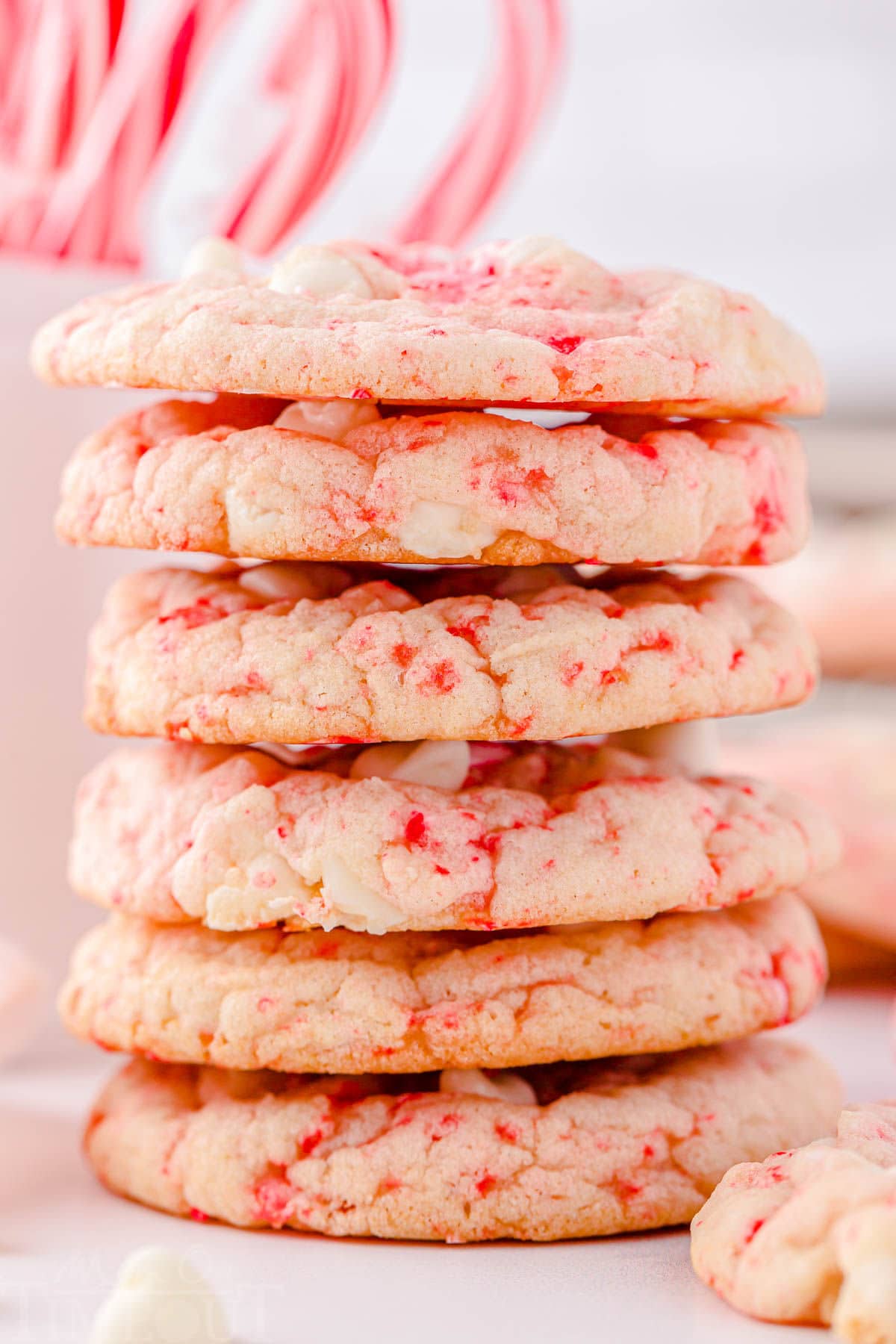 close up of stacked peppermint cookies with lots of white chocolate chips.