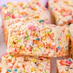 colorful rainbow rice krispie treats cut into squares and ready to enjoy.