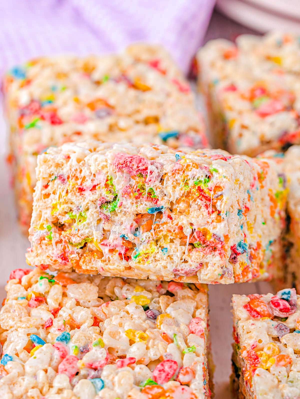 colorful rainbow rice krispie treats cut into squares and ready to enjoy.