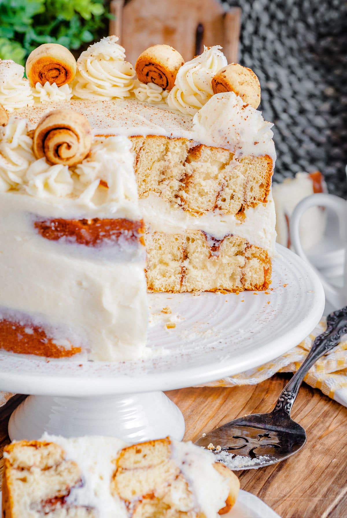 profile of cake with a slice removed so you can see the cinnamon swirls inside the cake.