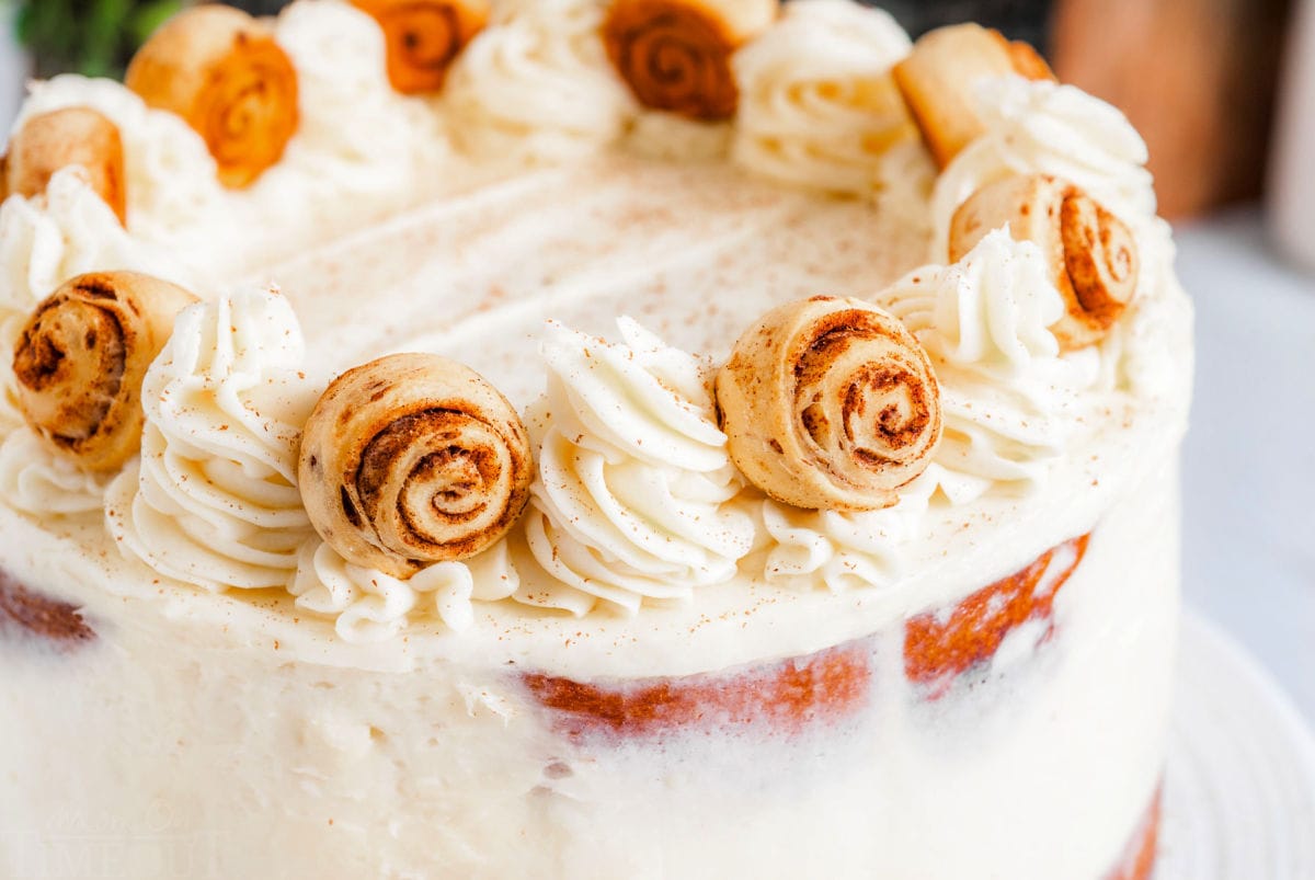 close up look at decorated cinnamon roll cake topped with mini cinnamon rolls and cream cheese buttercream.