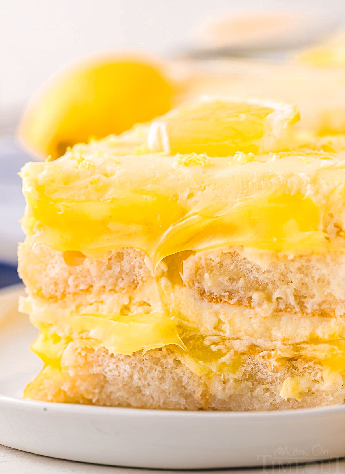 close up look at the wonderful layers in this lemon tiramisu recipe. the ladyfingers and lemon curd layers can be clearly seen. 