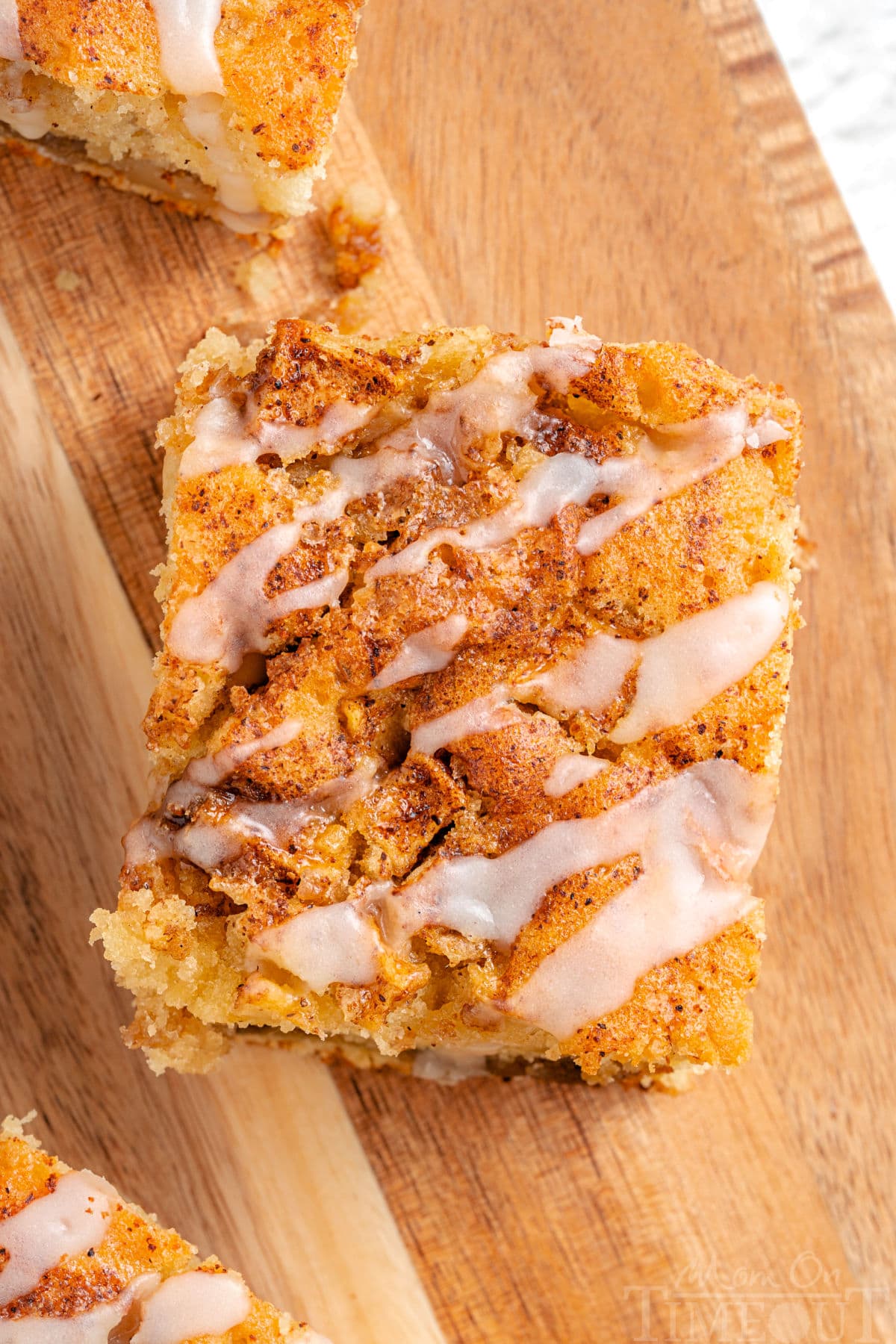 top down view of piece of apple cinnamon coffee cake with glaze drizzled on top of it.