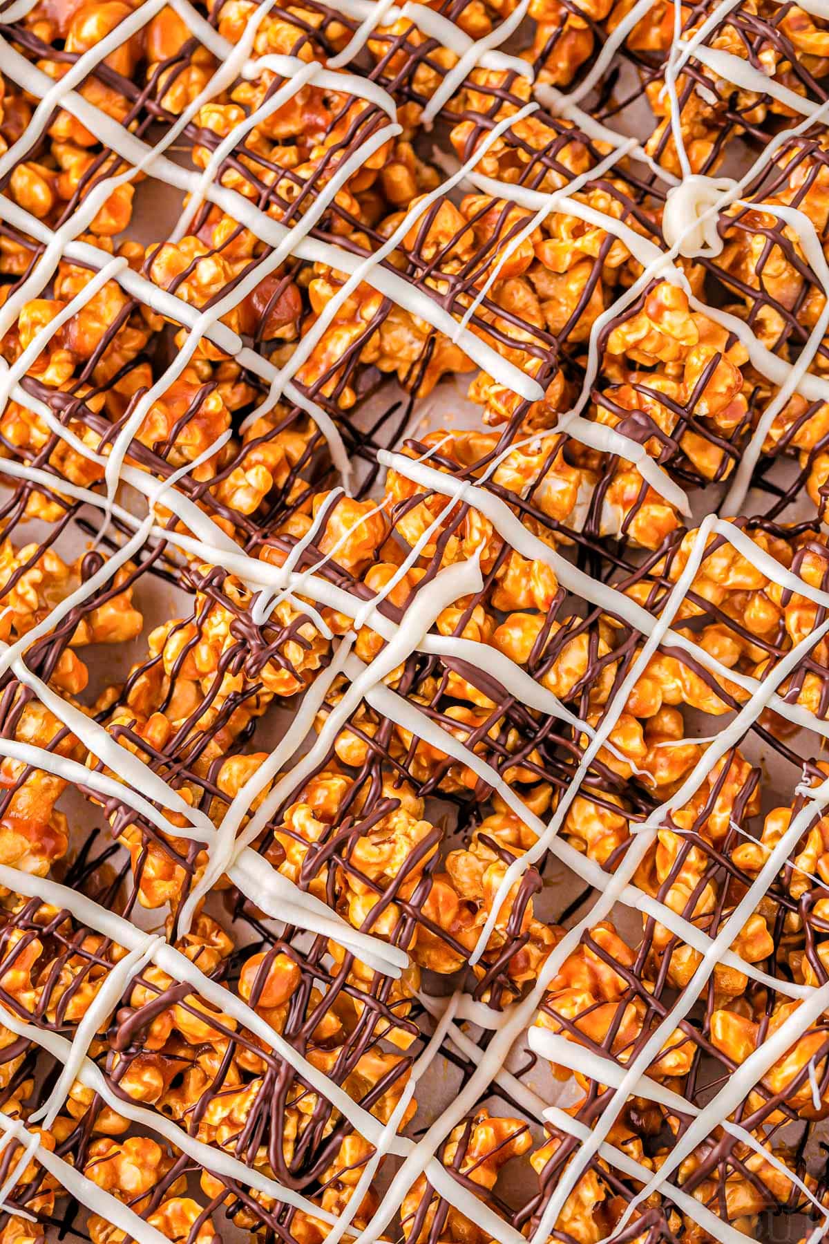 top down close up view of zebra popcorn recipe showing the chocolate drizzles on top of the caramel corn.