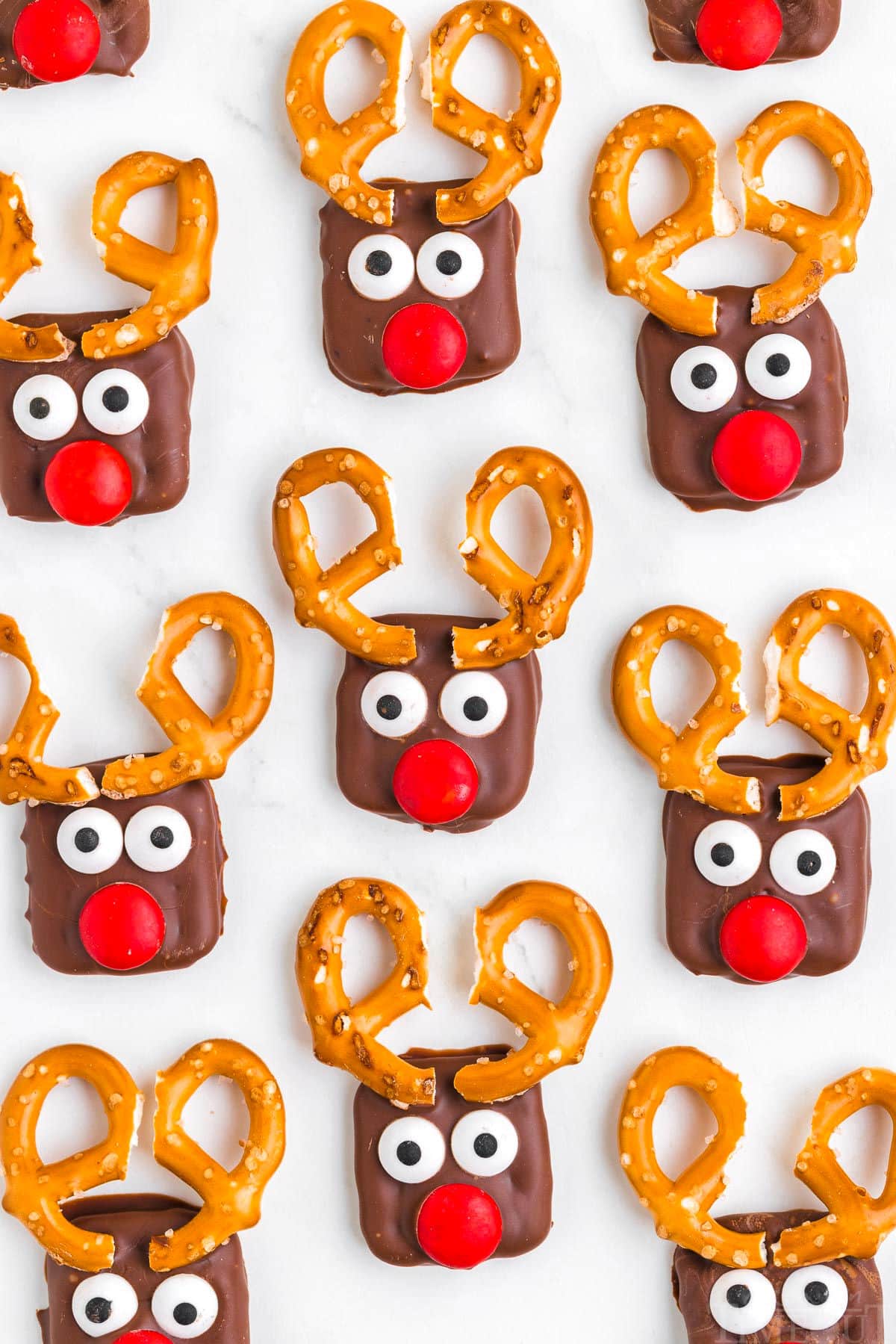 top down look at pretzel reindeer setting up on parchment lined baking sheet.