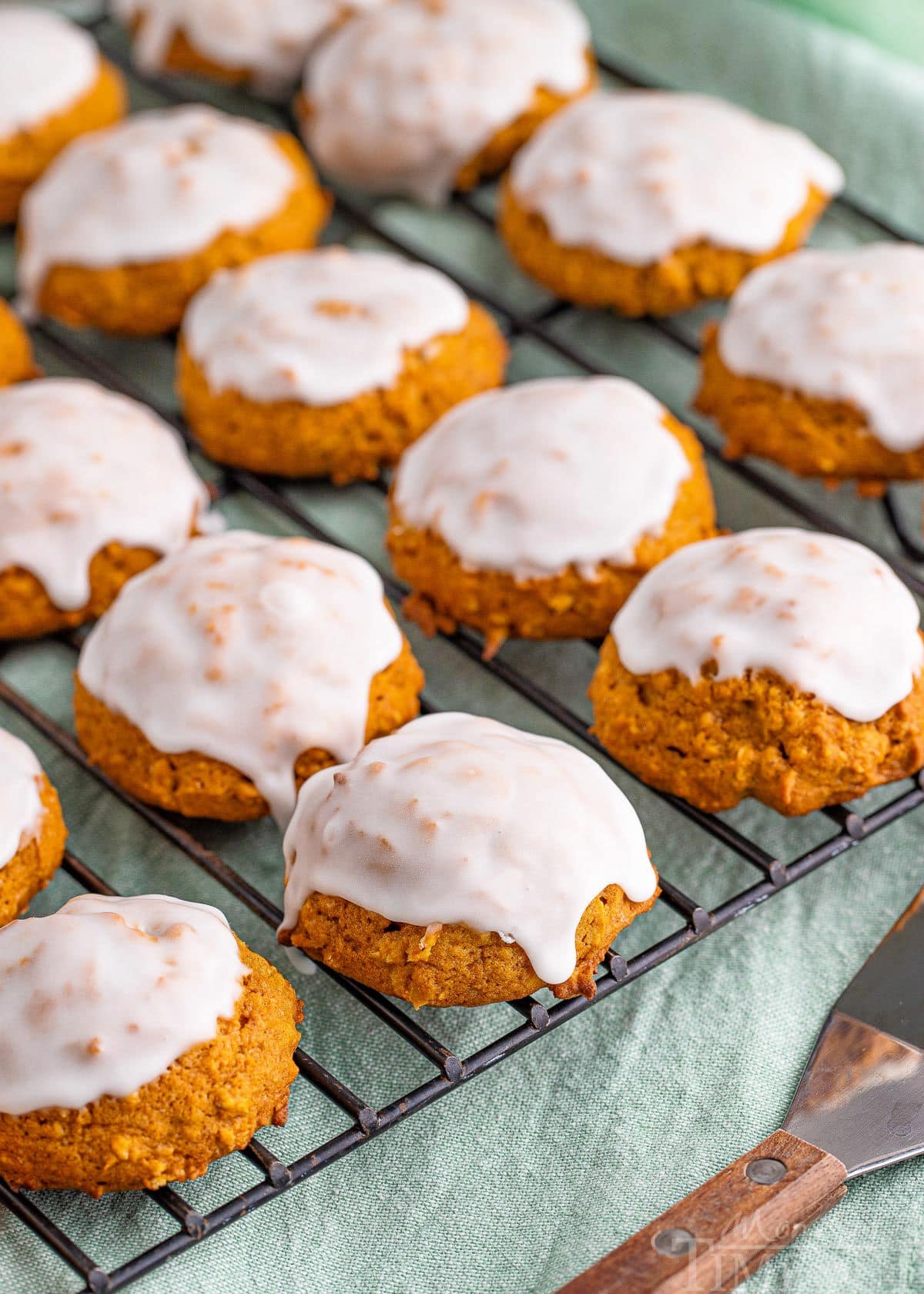 iced pumpkin oatmeal cookies on wire rack.