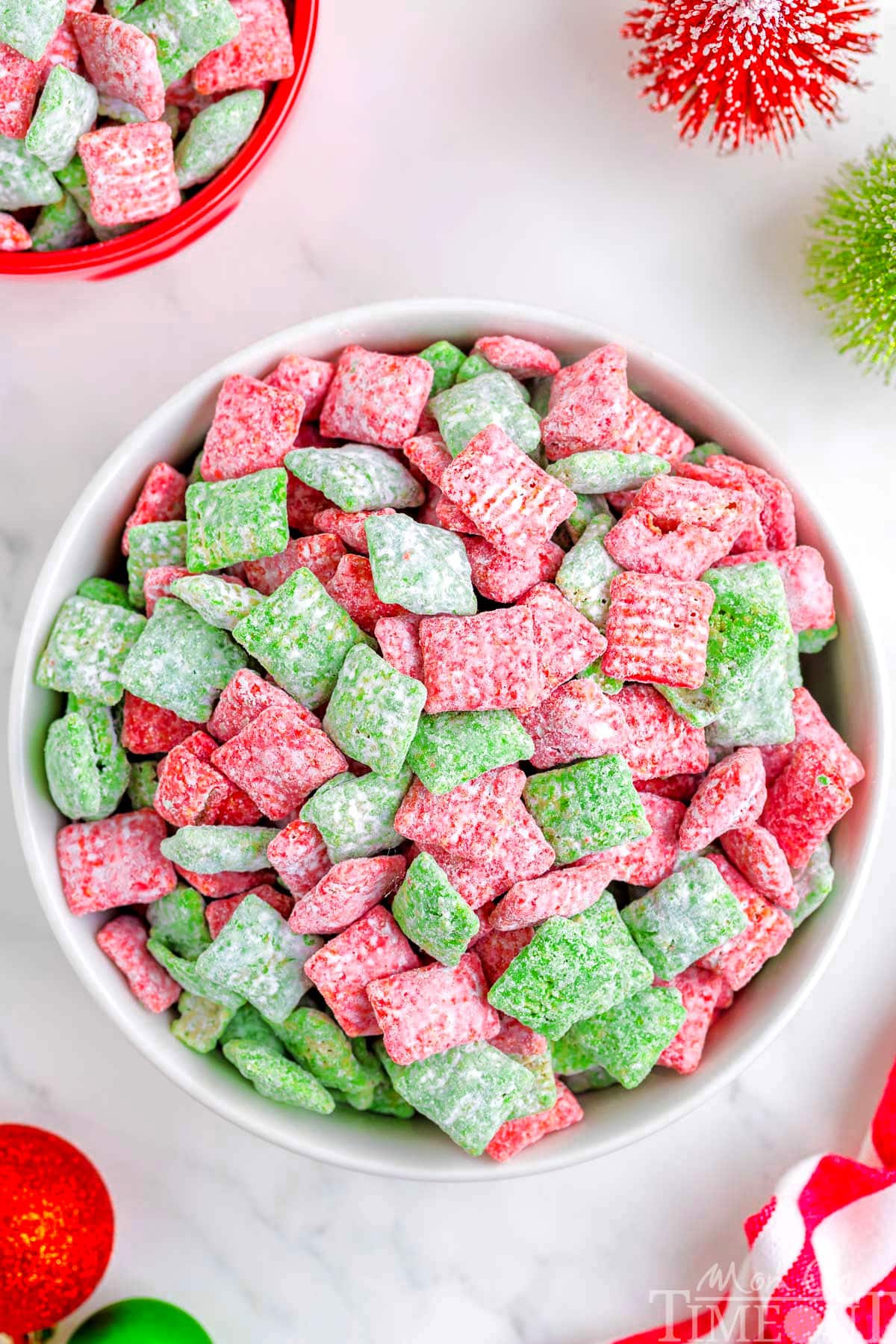 top down view of large white bowl filled with christmas muddy buddies made with red and green melts.