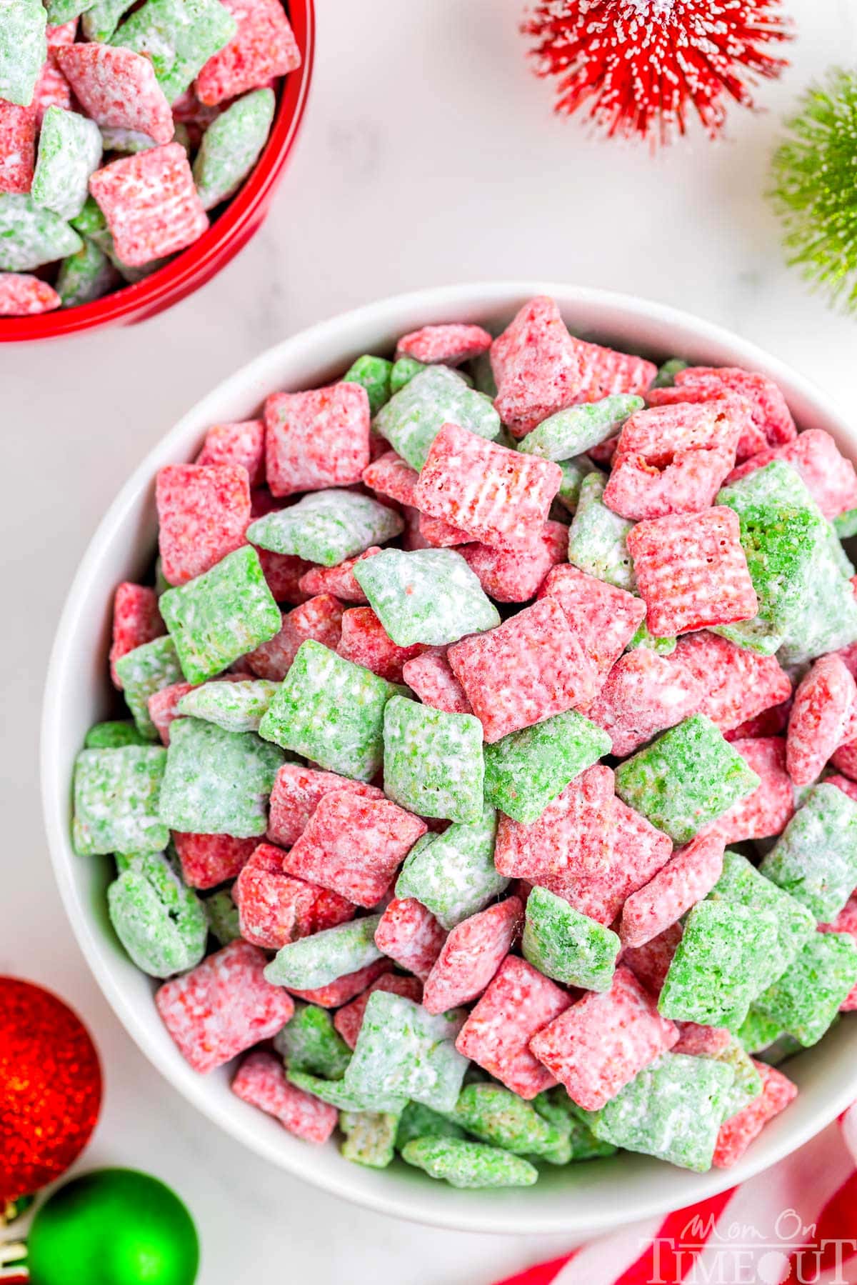 top down view of large white bowl filled with christmas muddy buddies made with red and green melts.