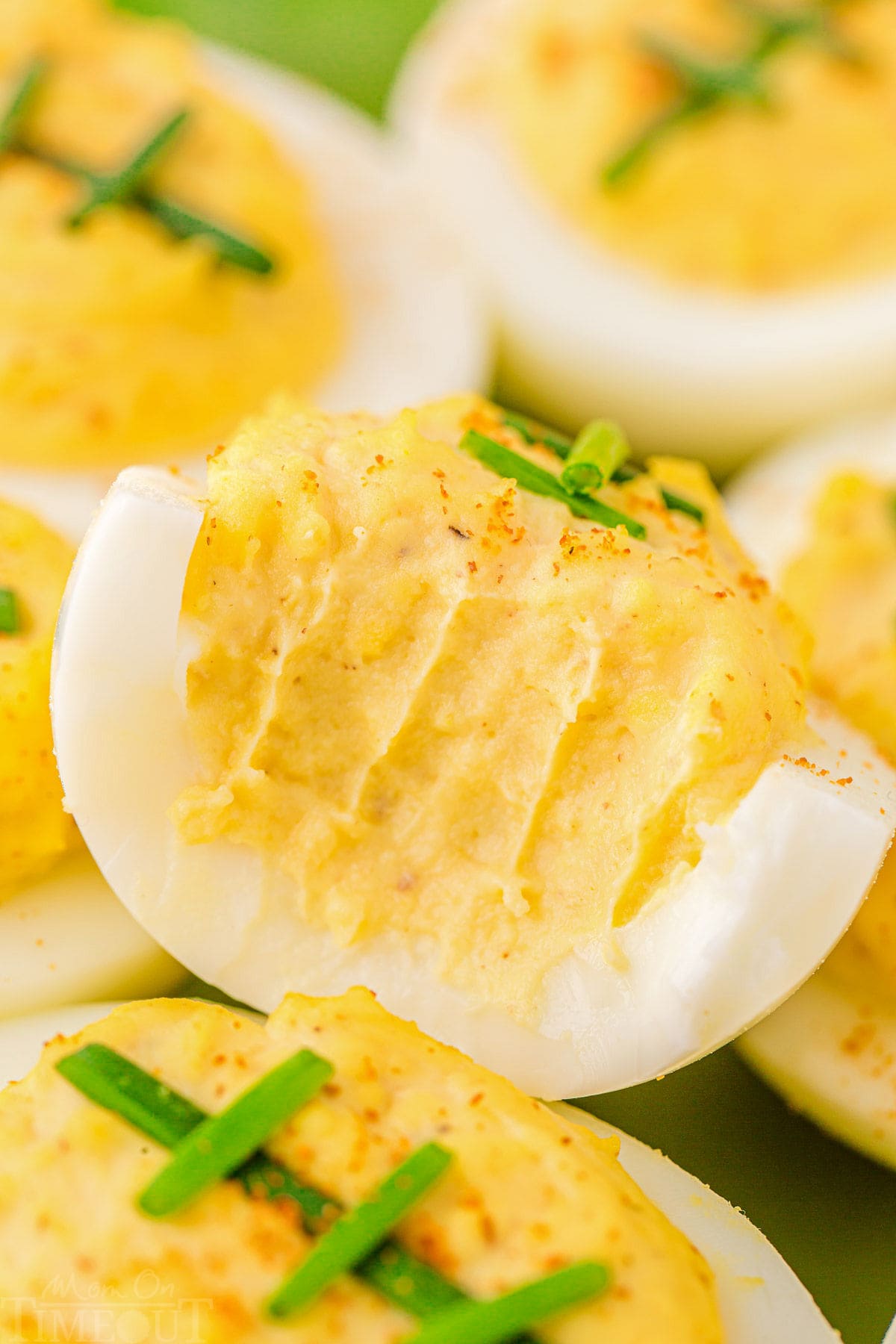 deviled eggs that are decorated to look like footballs. top deviled egg has a bite out of it.