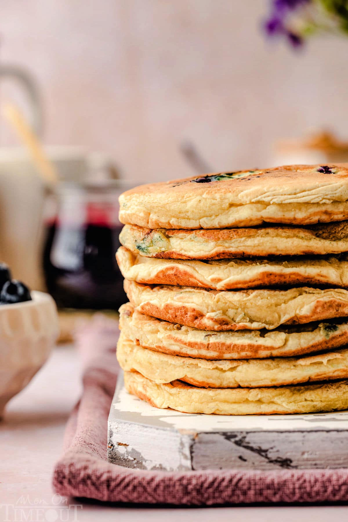 stack of lemon ricotta pancakes on a white board.