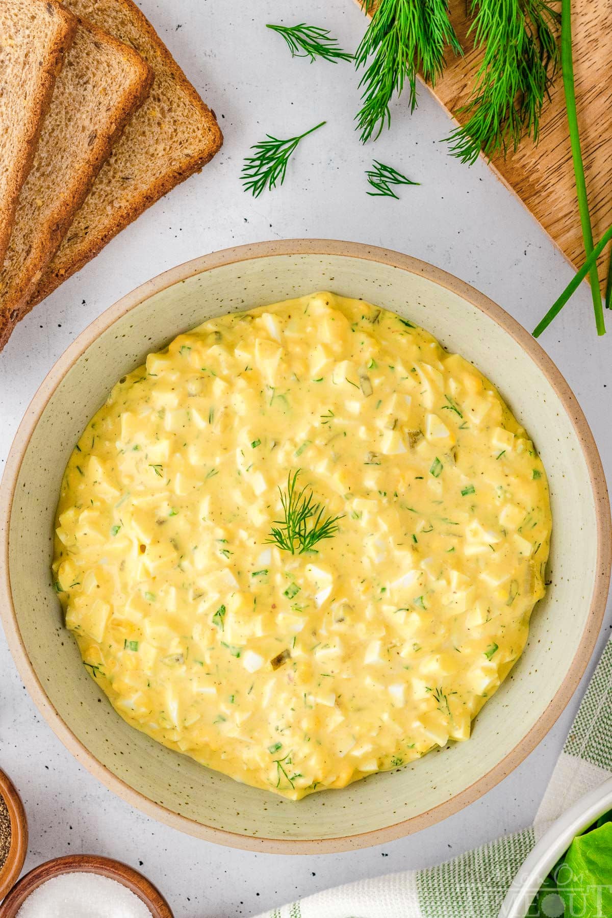A white bowl of egg salad.