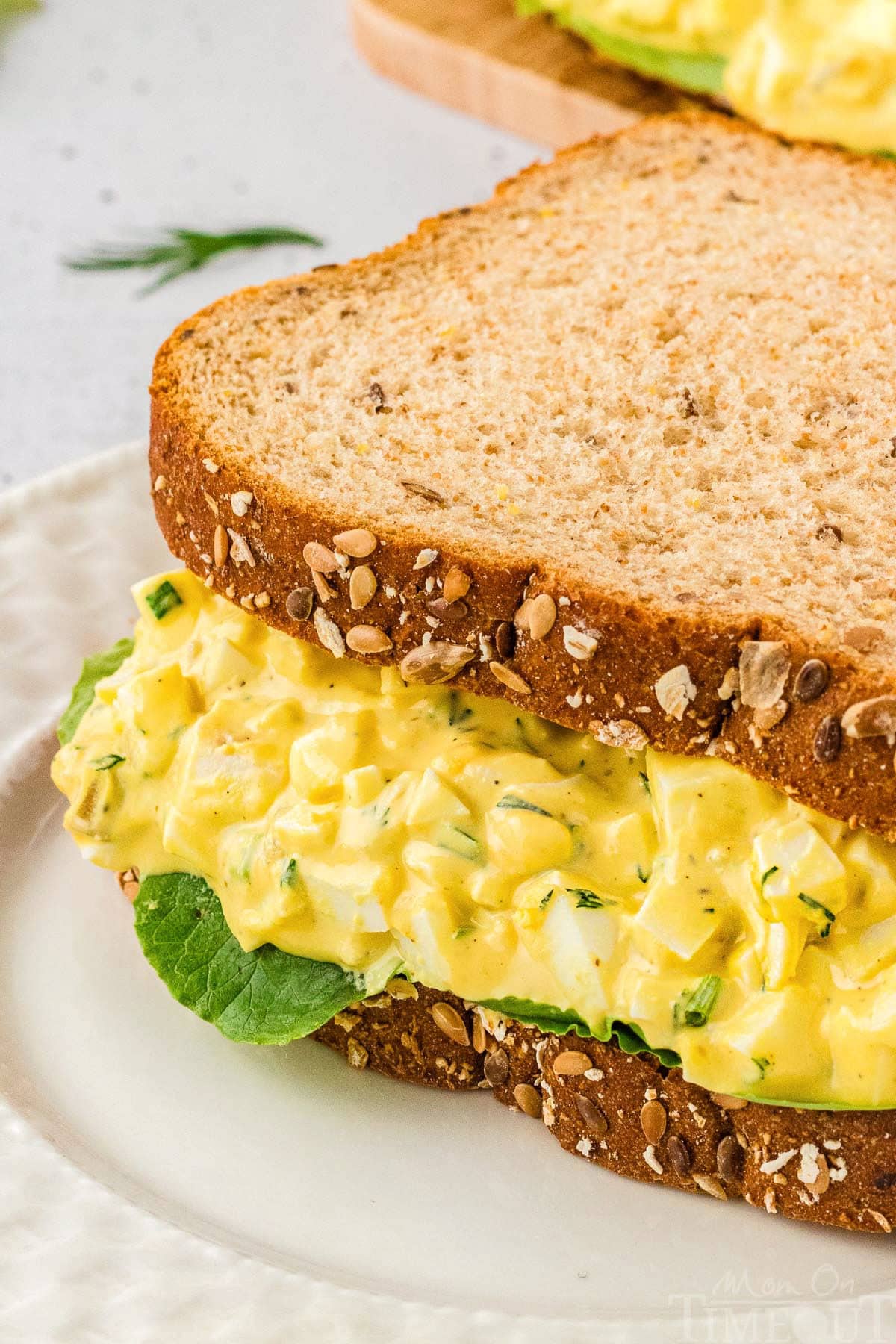 A close up view of an egg salad sandwich.