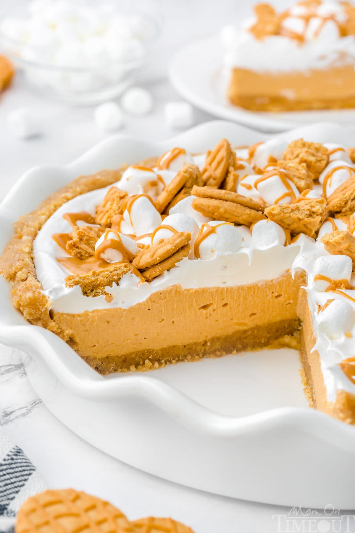 Fluffernutter Pie in white pie dish with one slice removed.