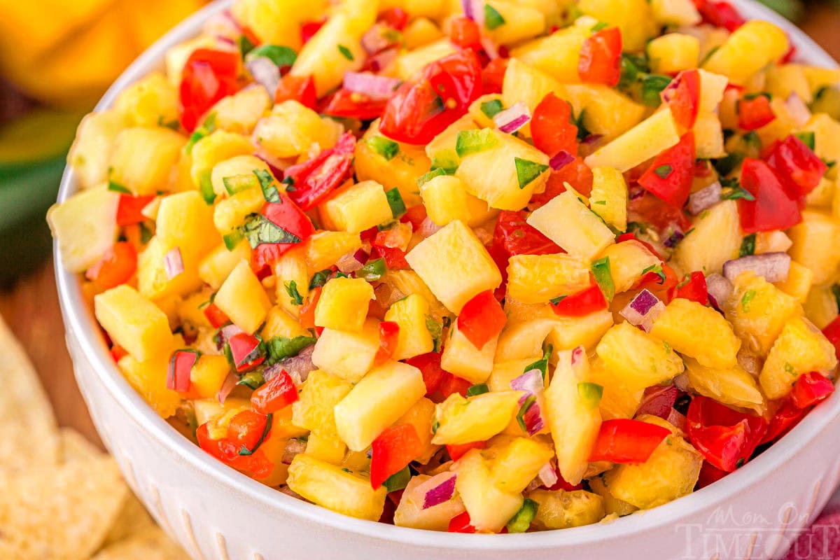 close up of tropical pineapple salsa in a white serving bowl.