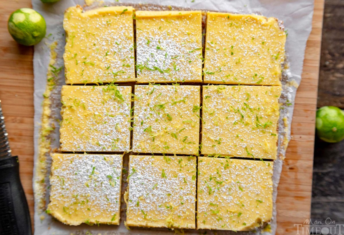 top down look at nine key lime bars cut into squares on a cutting board.