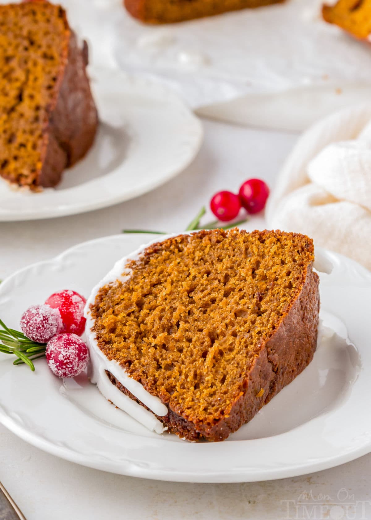 A slice of gingerbread bundt cake on a white plate.