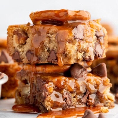 A stack of blondies with salted caramel sauce drizzled on top.