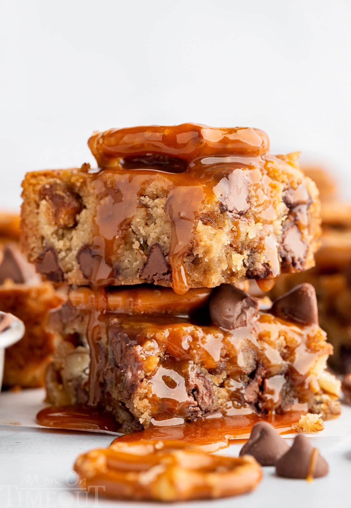 A stack of blondies with salted caramel sauce drizzled on top.