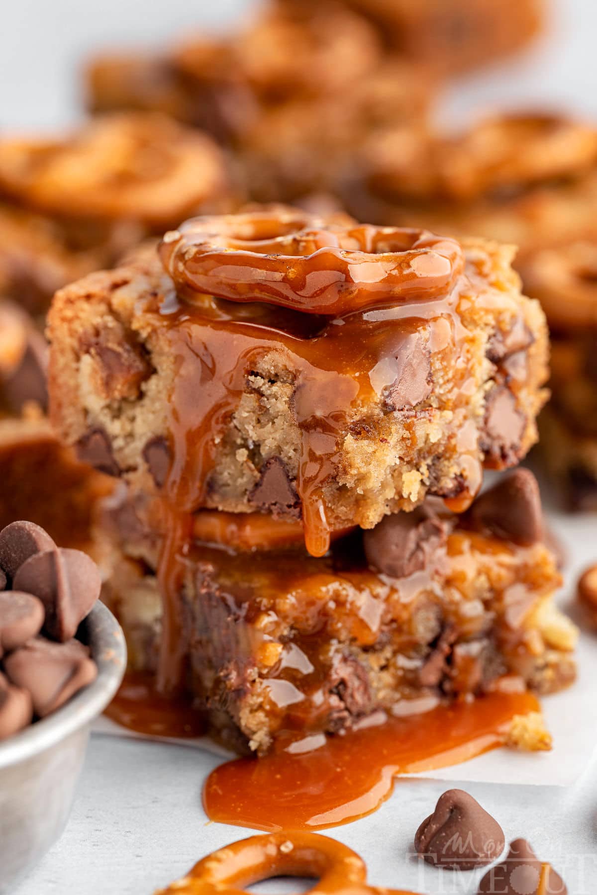 Salted Caramel Blondies in a stack with a drizzle of salted caramel on top.