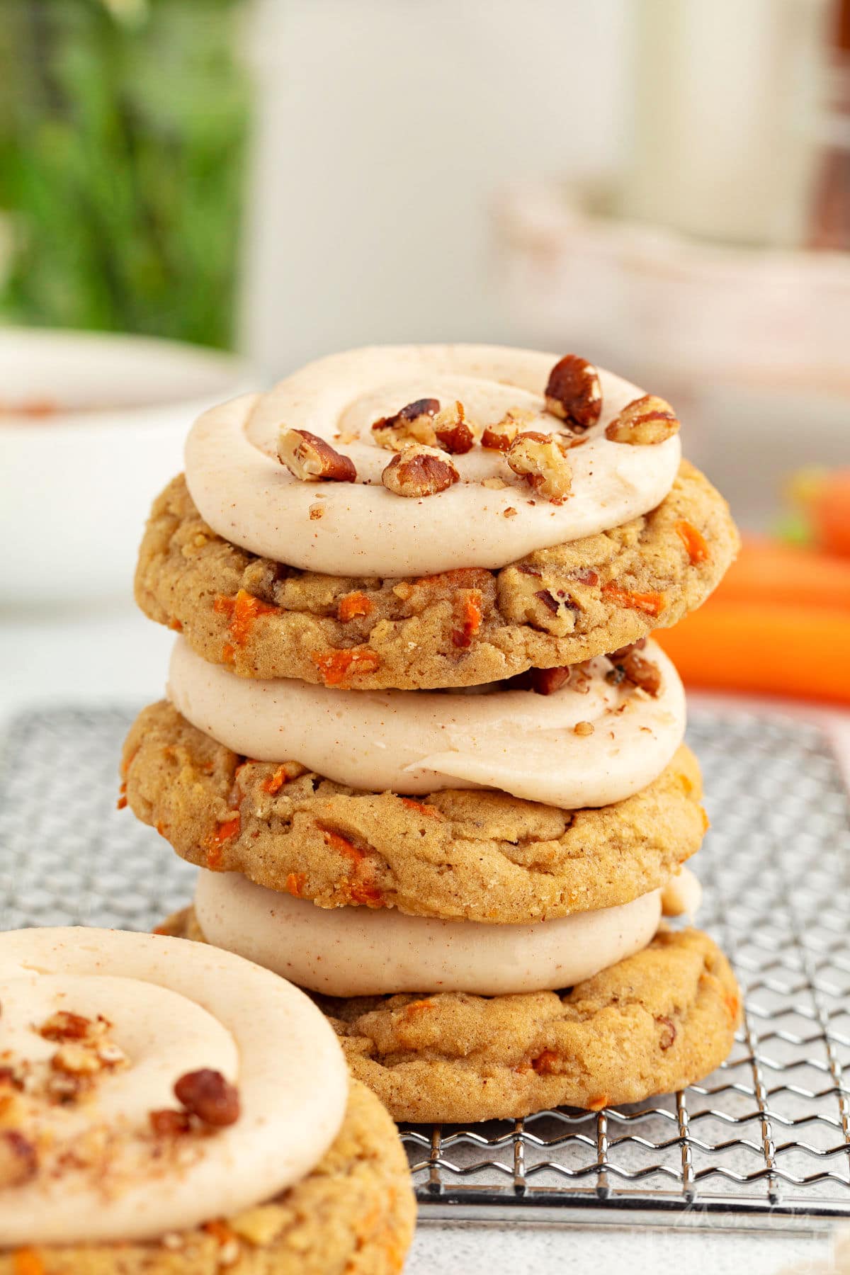 Carrot Cake Cookies stacked up on a cooling rack.