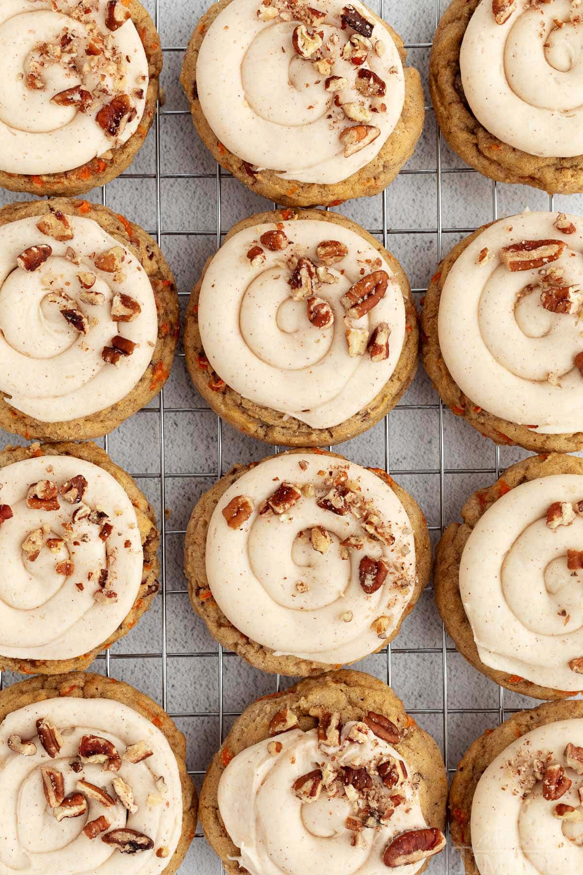 Carrot Cake Cookies lined up on a cooling rack.