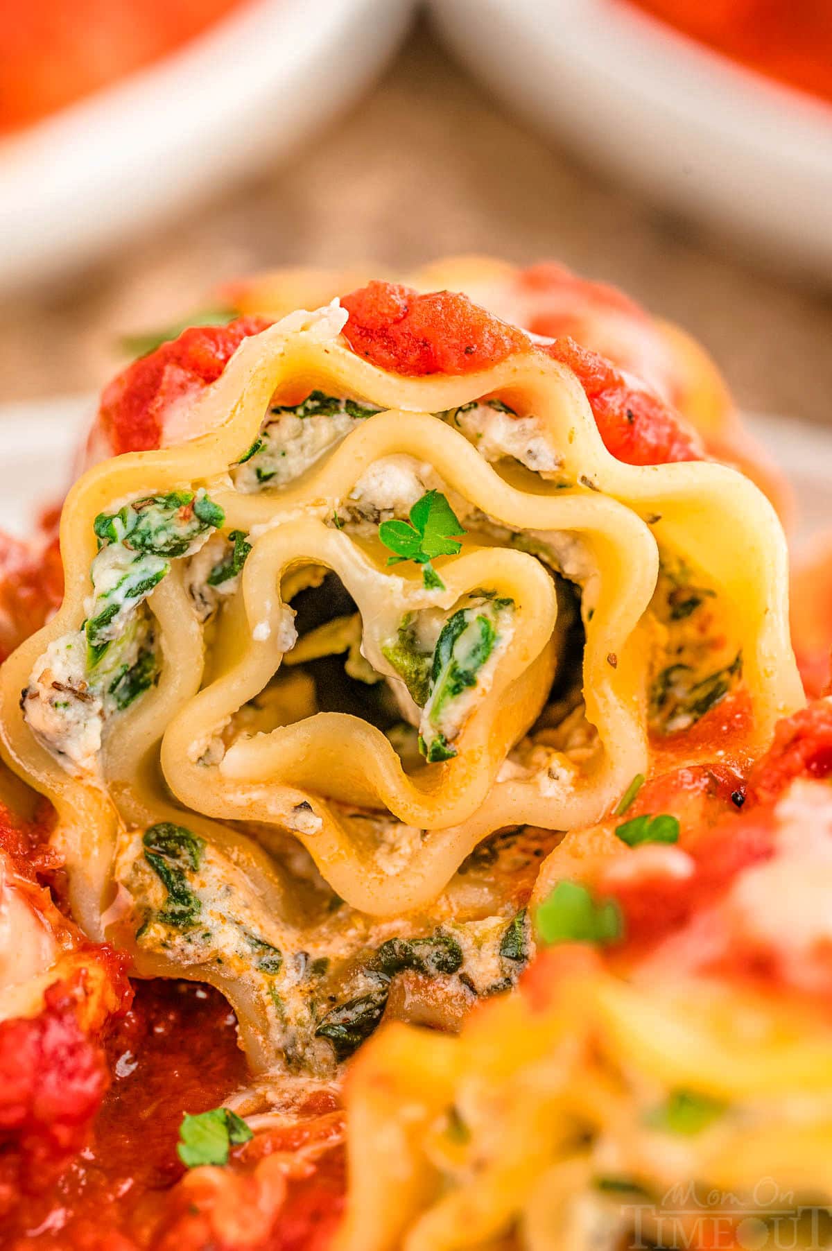 Close up look at lasagna roll up on plate.