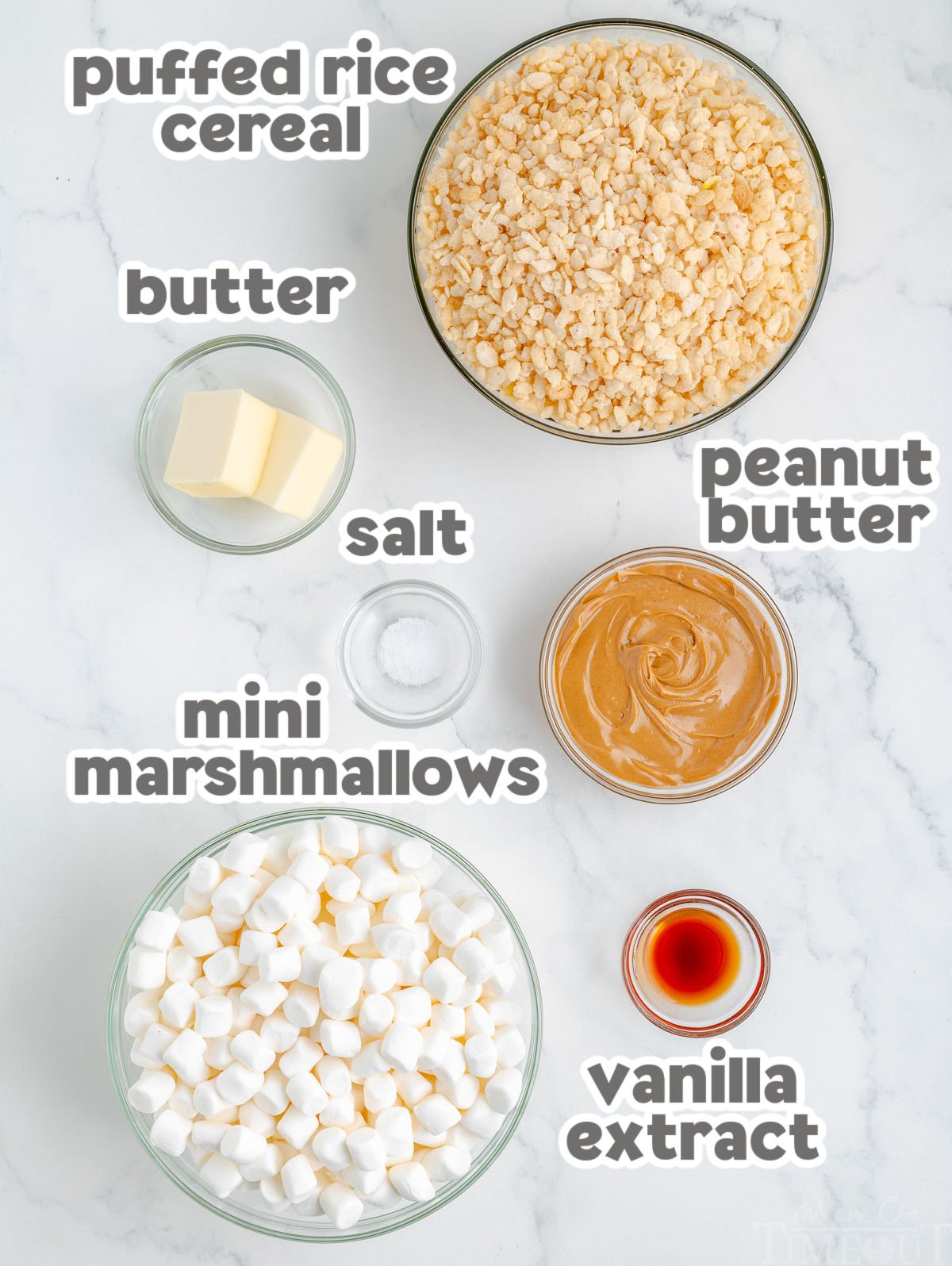 Overhead shot of peanut butter rice krispie treat ingredients measured out into shallow bowls ready to be used in the recipe.