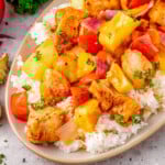 Close up look at Hawaiian Chicken recipe plated with rice on an oval plate.