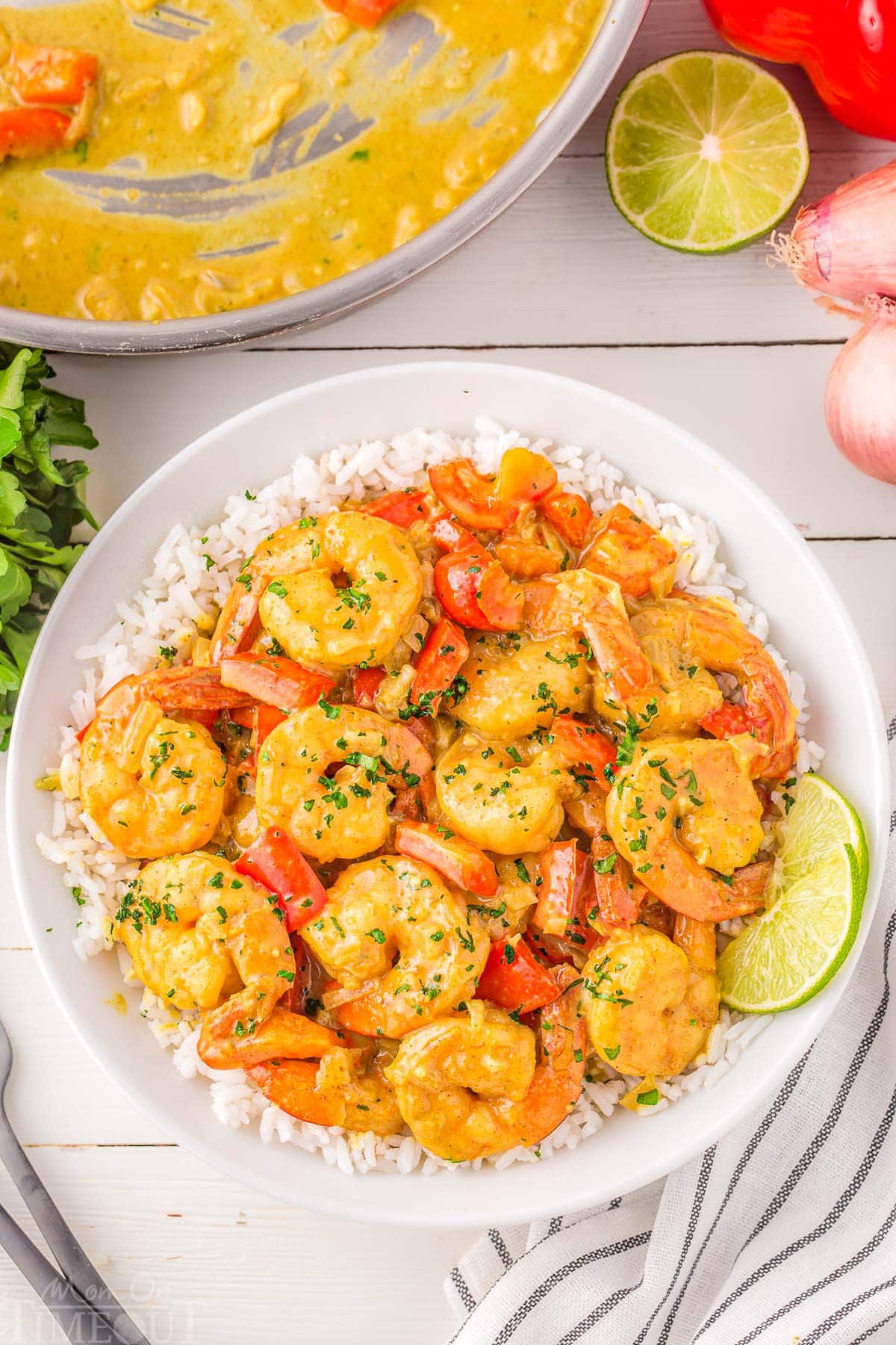 Overhead shot of coconut shrimp bowl served with rice in round white bowl.