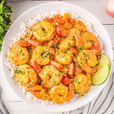 Overhead shot of coconut shrimp bowl served with rice in round white bowl.