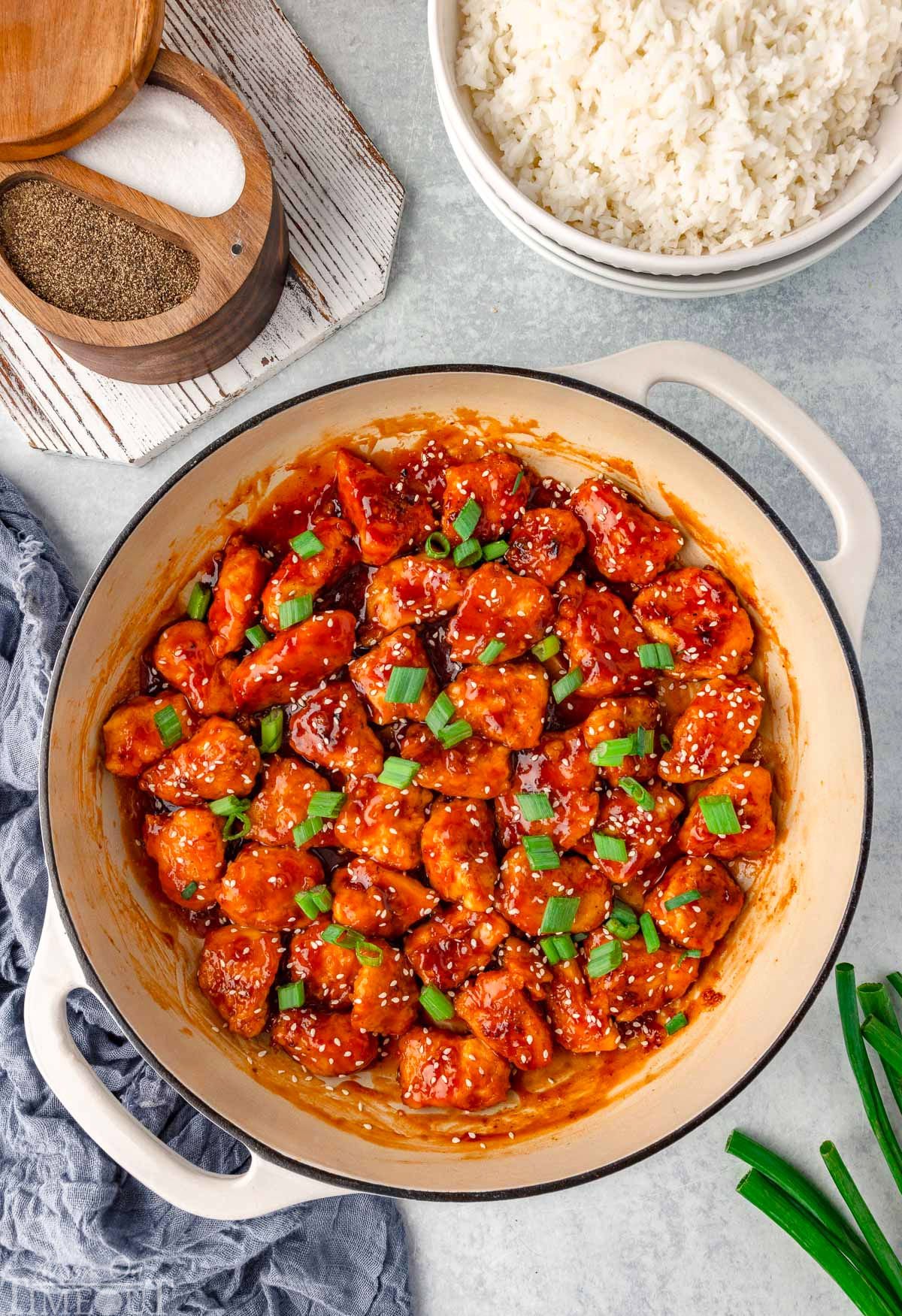 Overhead shot of honey sesame chicken in skillet ready to be served.