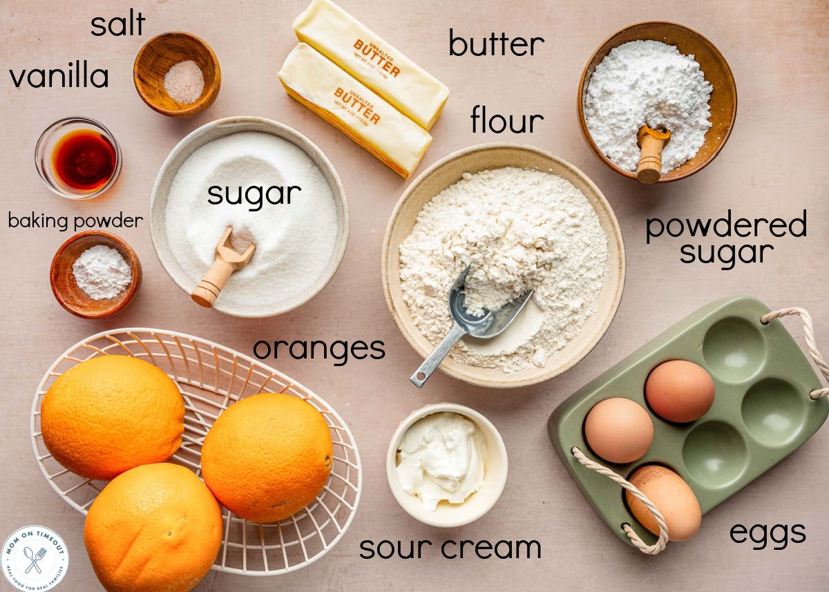 Overhead shot of orange pound cake ingredients measured out into small bowls ready to be used in the recipe.