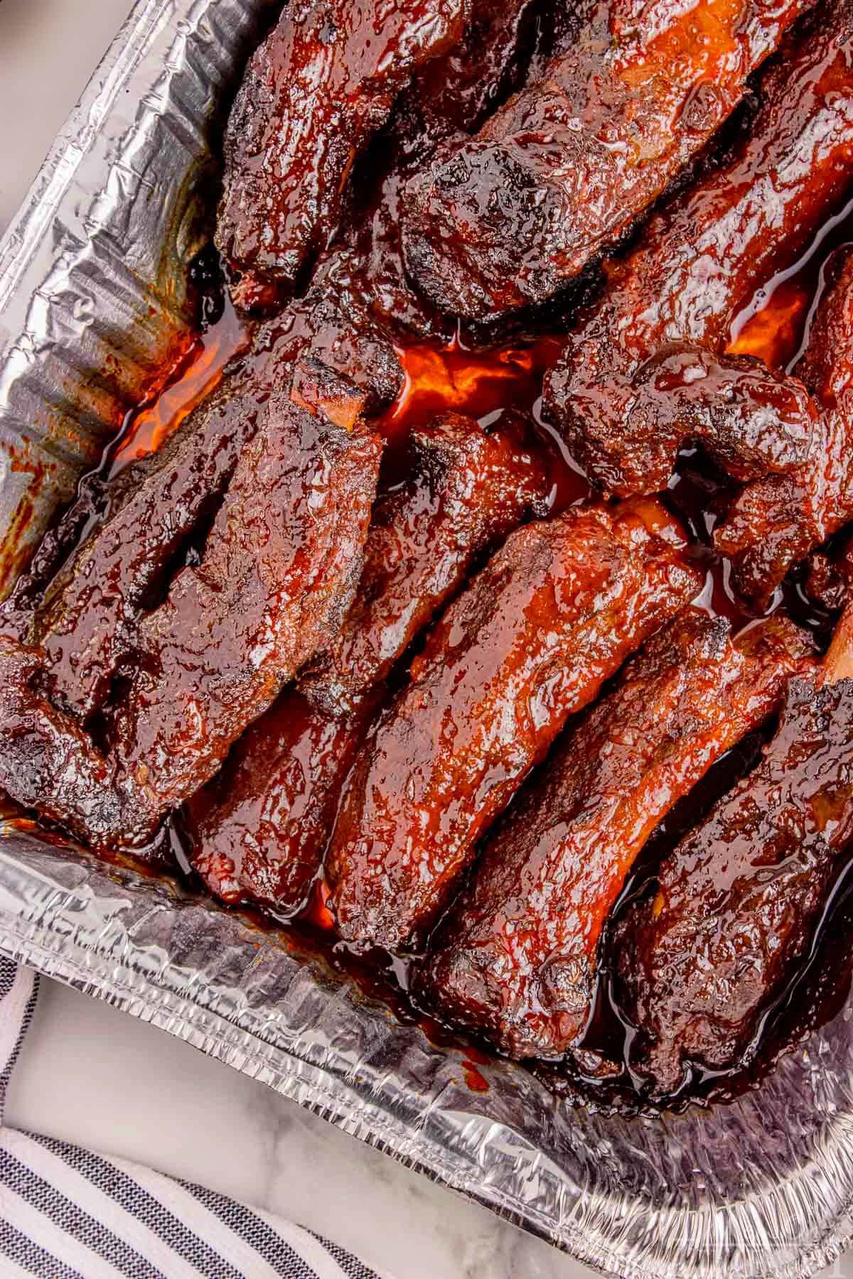 Overhead shot of party ribs in foil pan ready to serve.