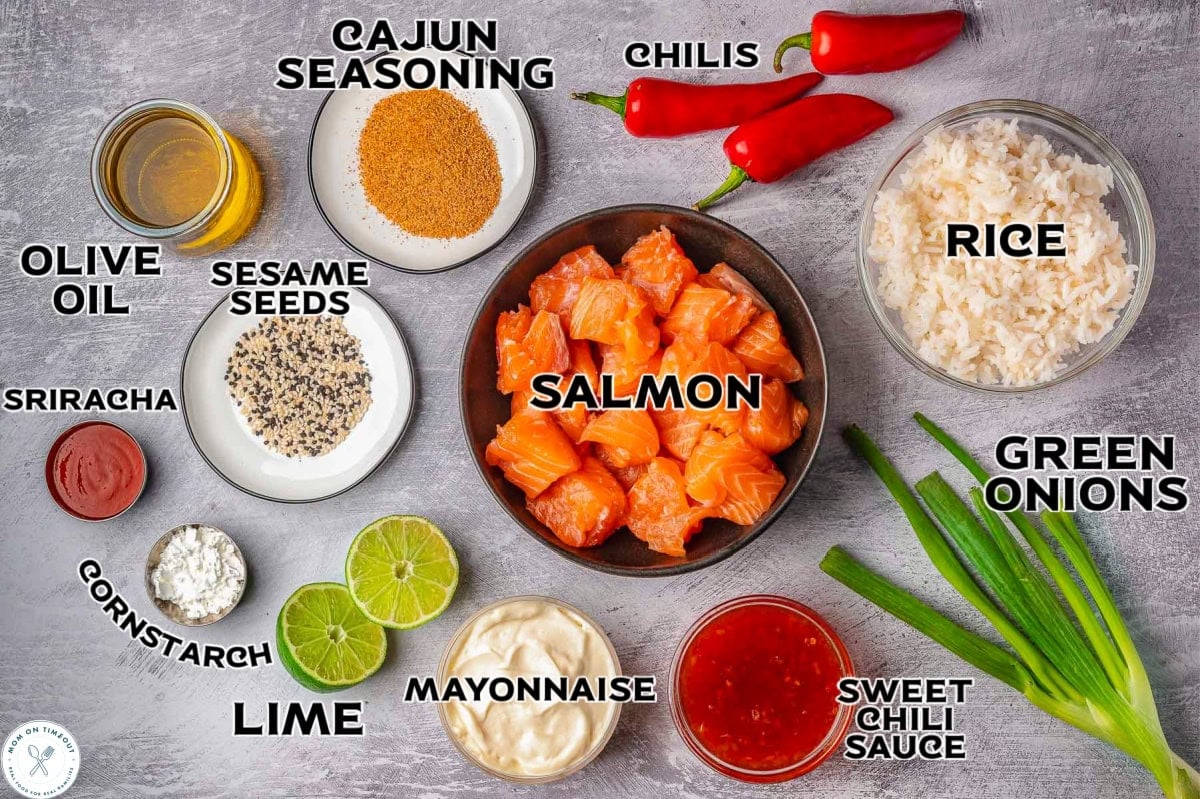 Overhead shot of bang bang salmon bites ingredients measured out into small bowls and ready to be used in the recipe. Each ingredient with a text label.