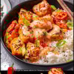 Two image graphic showing Bang Bang Salmon Bites recipe in a black bowl with rice and a piece held up with chopsticks. Text overlay at top and bottom of image.