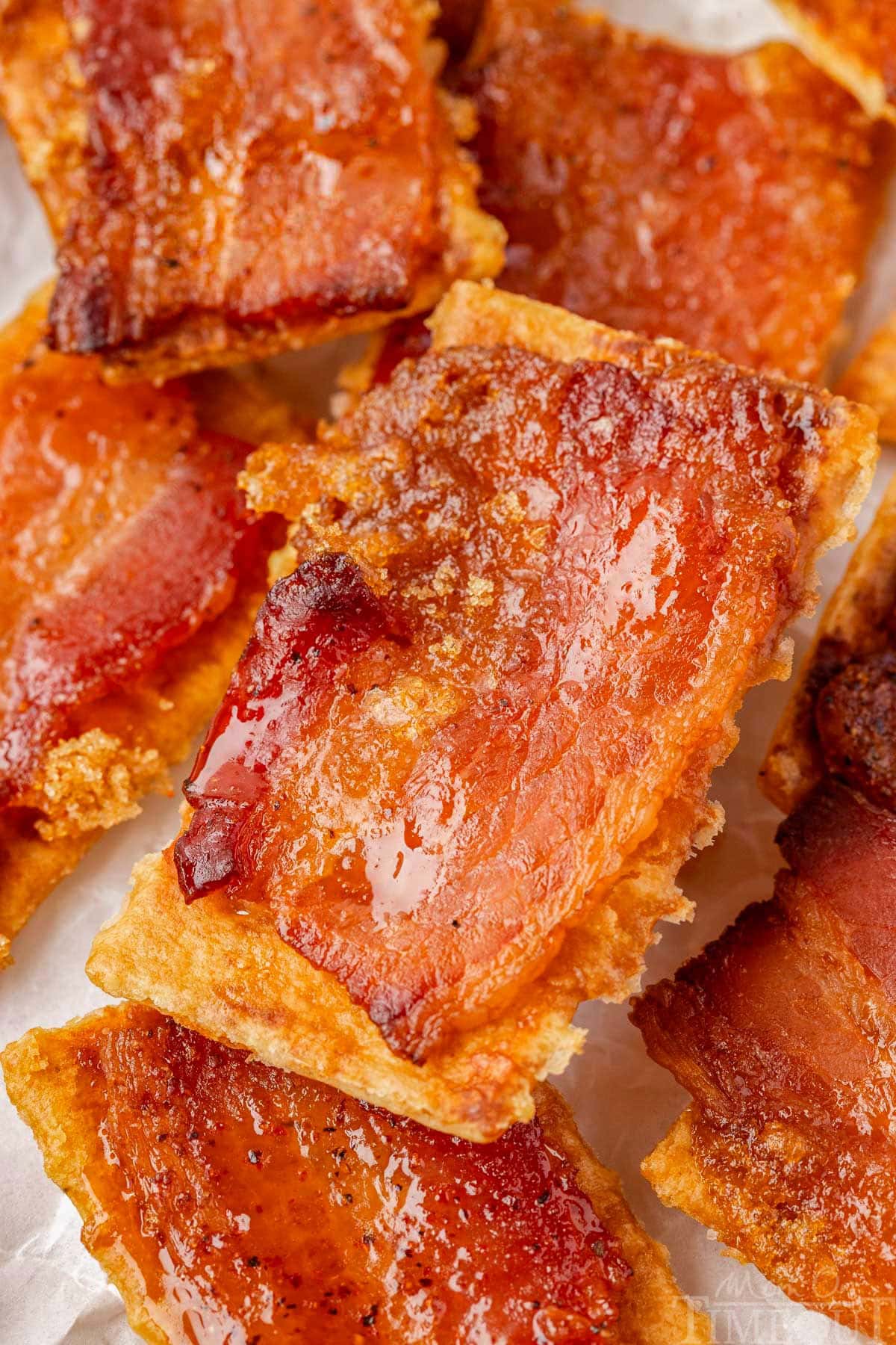 Close up shot of candied bacon crackers recipe in a pile.