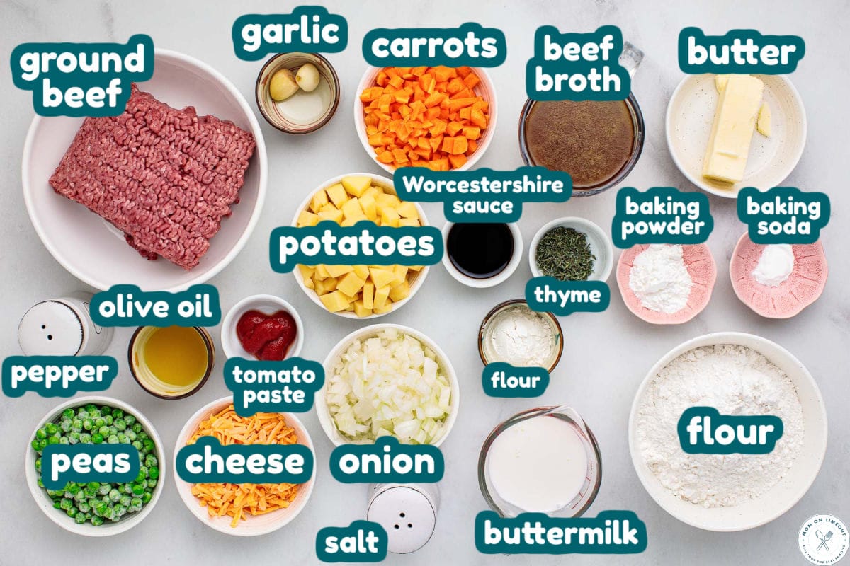Overhead shot of ground beef pot pie ingredients measured into small bowls ready to be used in the recipe. Each ingredients is labeled.