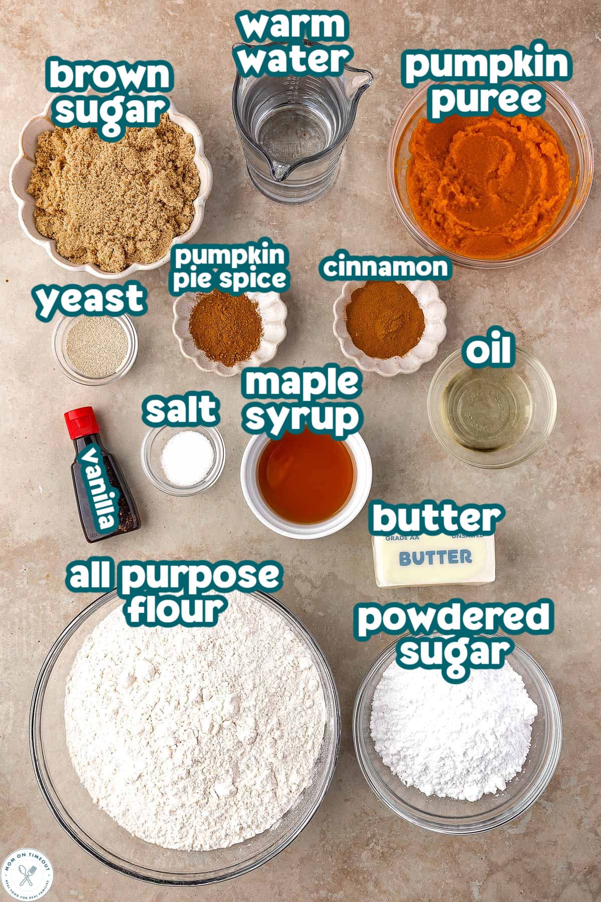 Overhead shot of pumpkin cinnamon roll focaccia ingredients measured out into small bowls and labeled.
