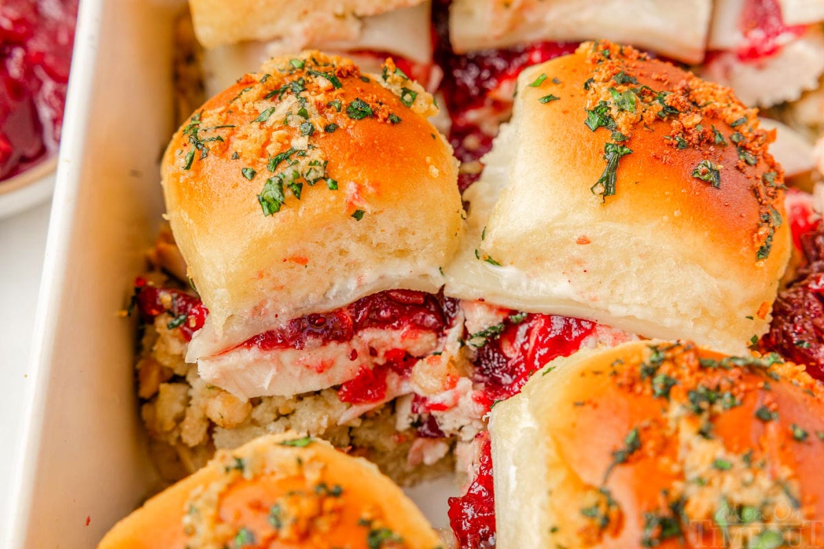 Wide shot of turkey cranberry sliders in white baking dish.