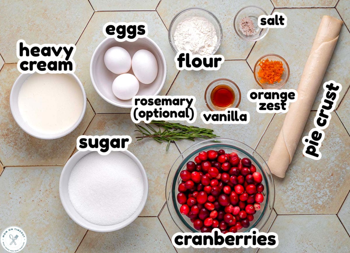 Overhead shot of cranberry pie ingredients measured out and ready to use in the recipe. Each ingredient is labeled.