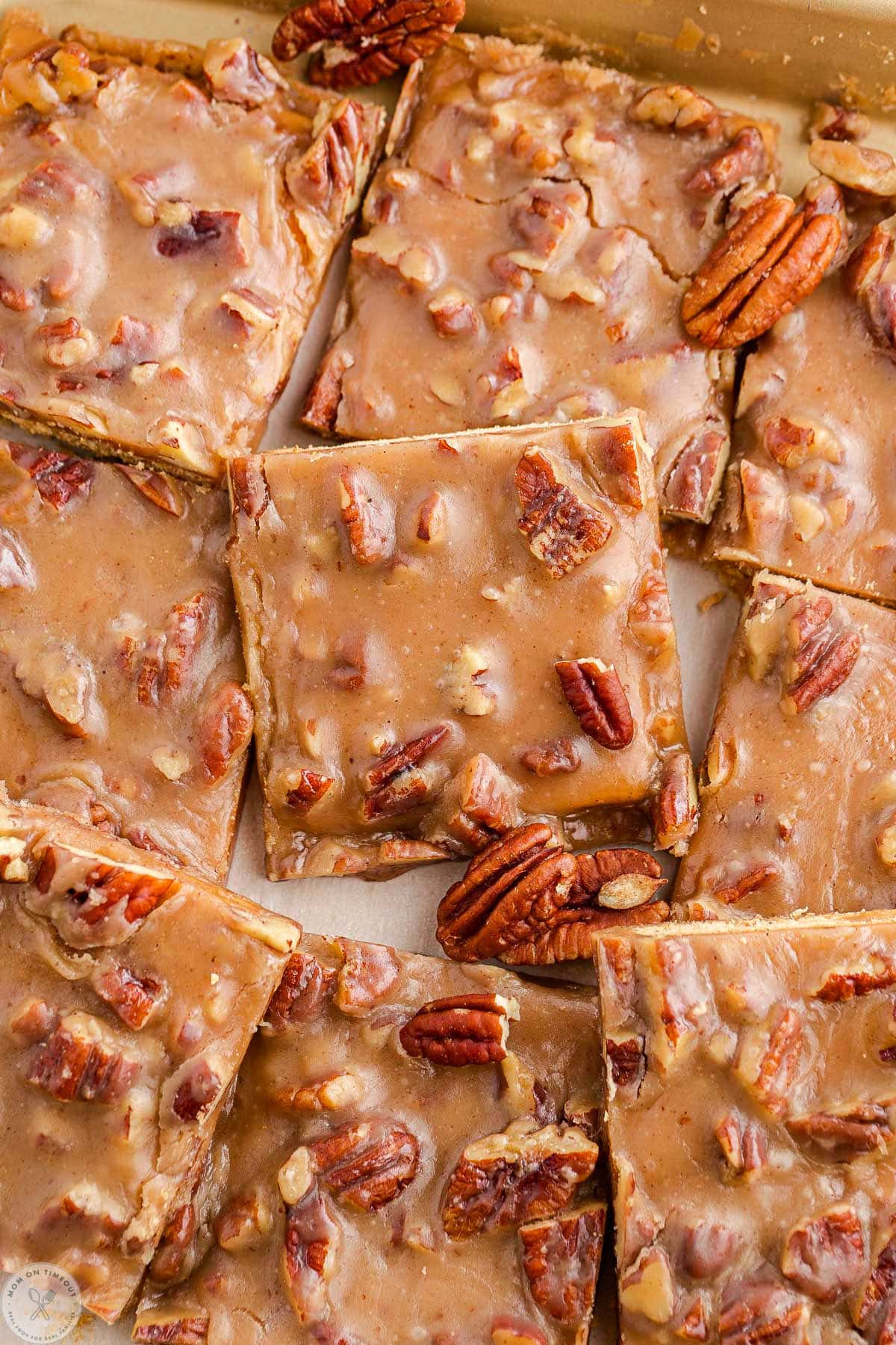 Close up shot of cut pieces of recipe for pecan pie bark laid in sheet pan.