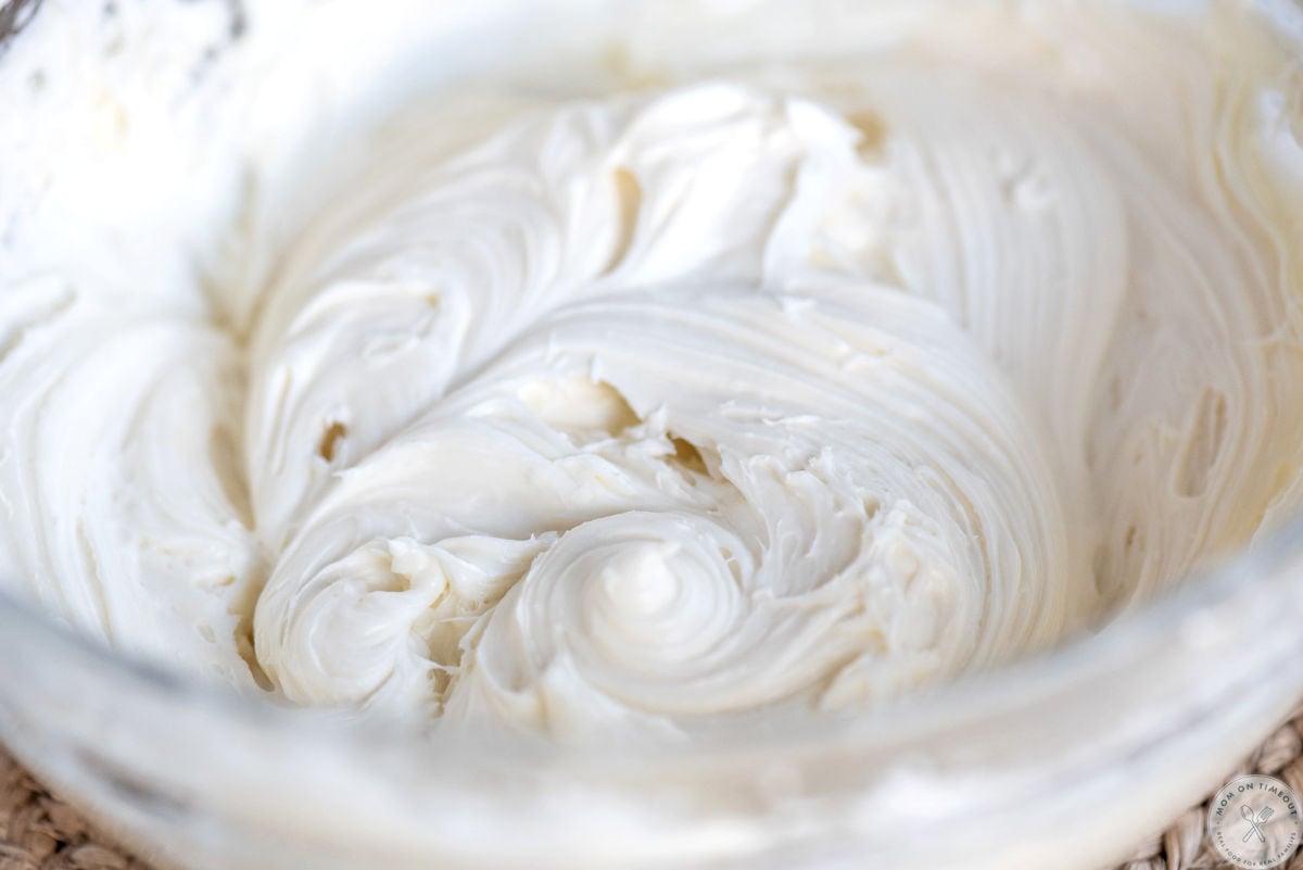 Big glass bowl of cream cheese frosting.