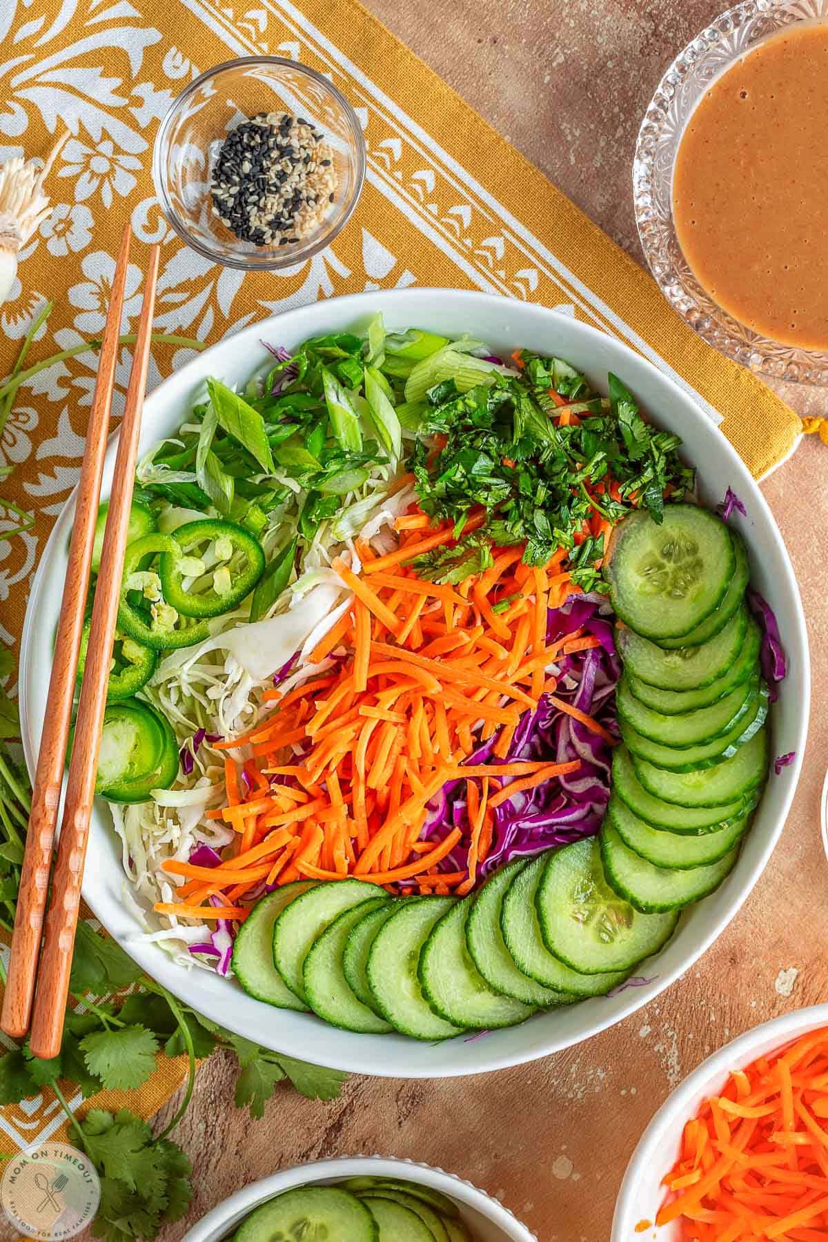 Thai salad ingredients laid out in white bowl.
