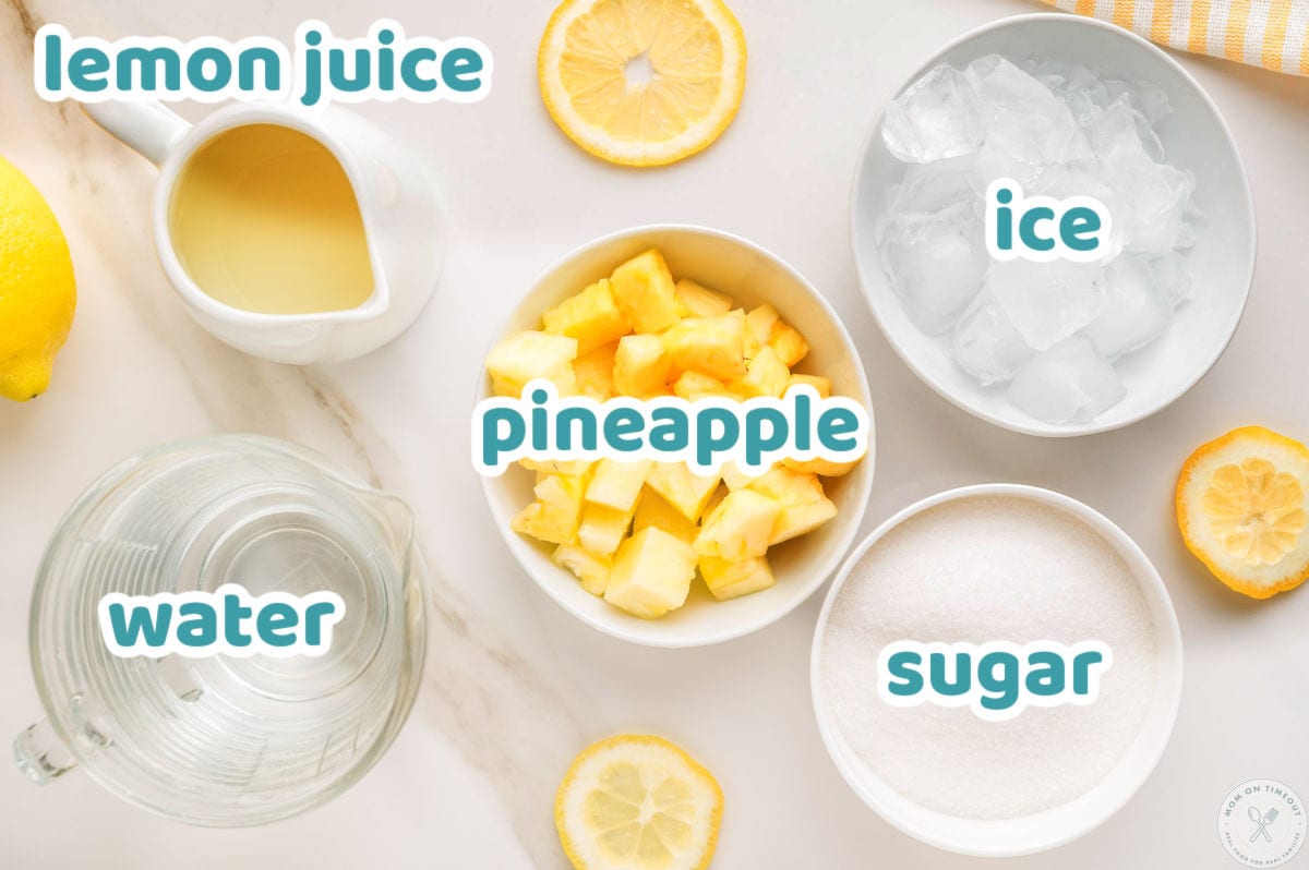 Overhead shot of pineapple lemonade ingredients laid out, labeled, and ready to be used in the recipe.